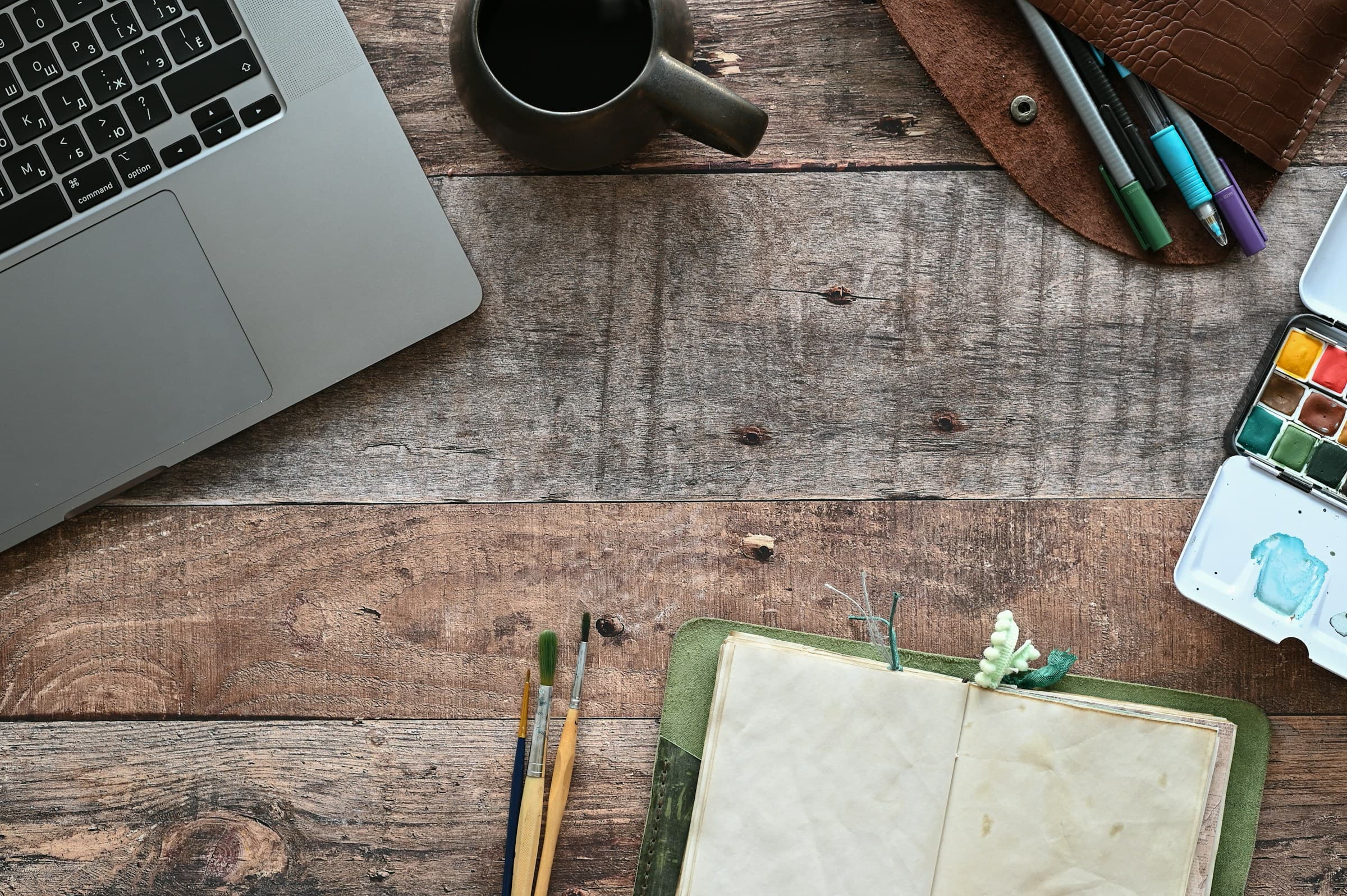 A clinician's workspace — notebook, laptop, the work itself