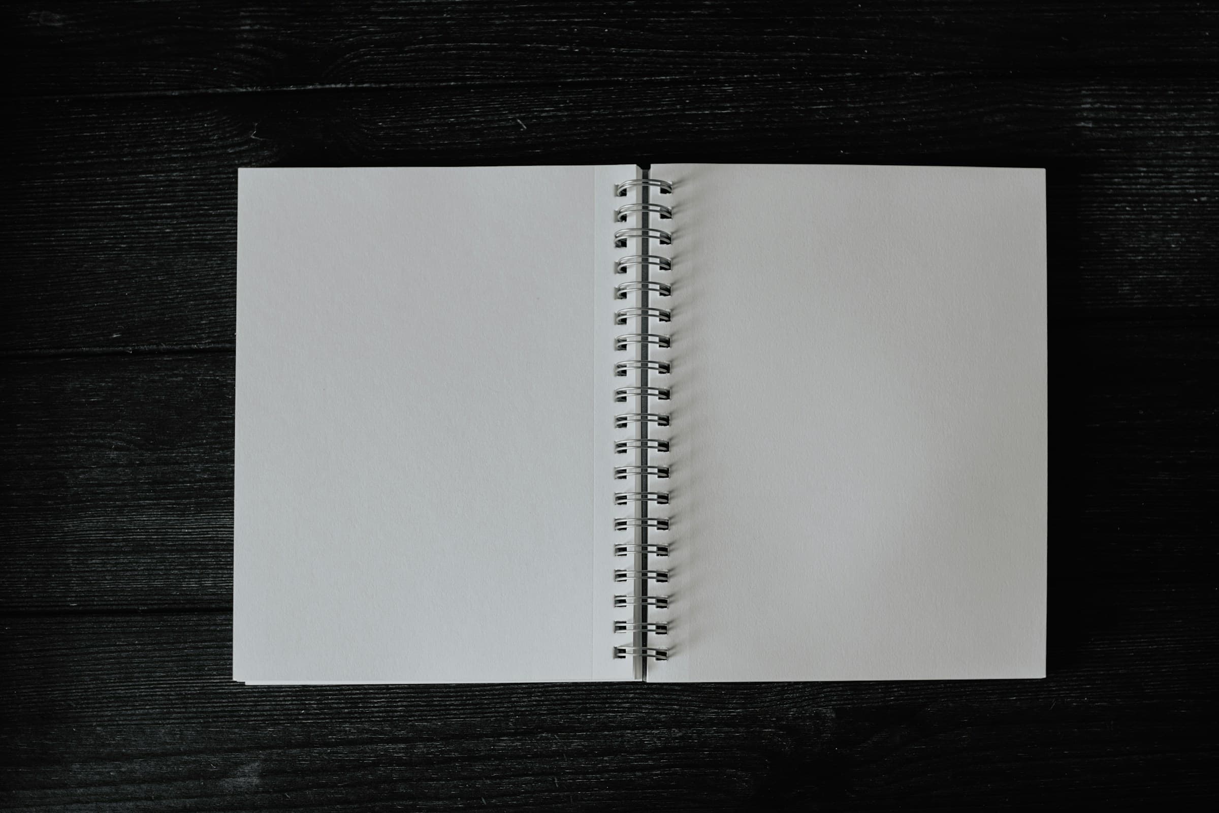 Open notebook on a wooden desk — the kind of careful documentation Auxo is built around